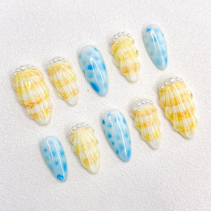 Pearl Shell press-on nails with seashell designs and gentle wave patterns, capturing the calming essence of the ocean.