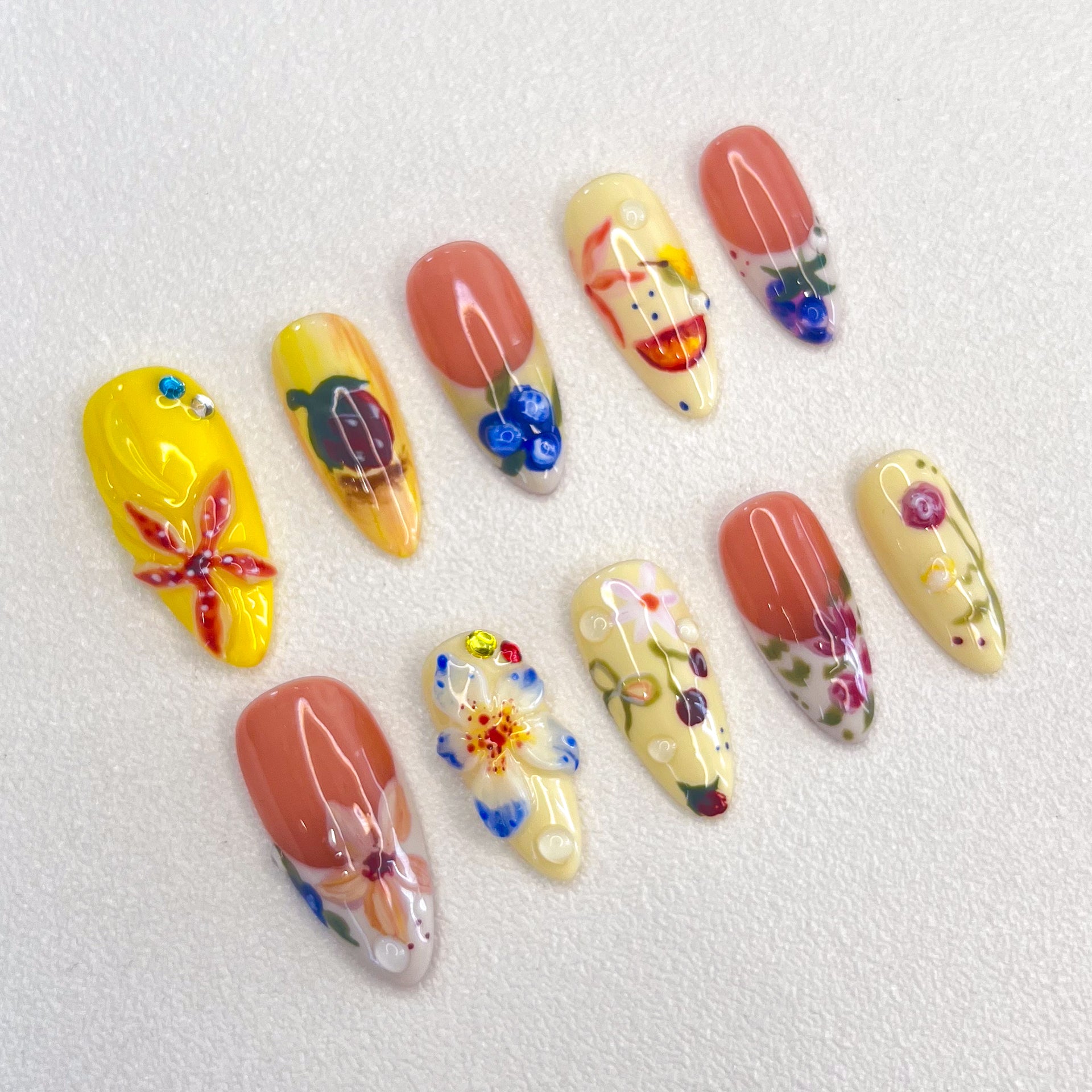 Garden Party press-on nails with colorful flowers and leaves, perfect for capturing the lively spirit of a blooming garden.