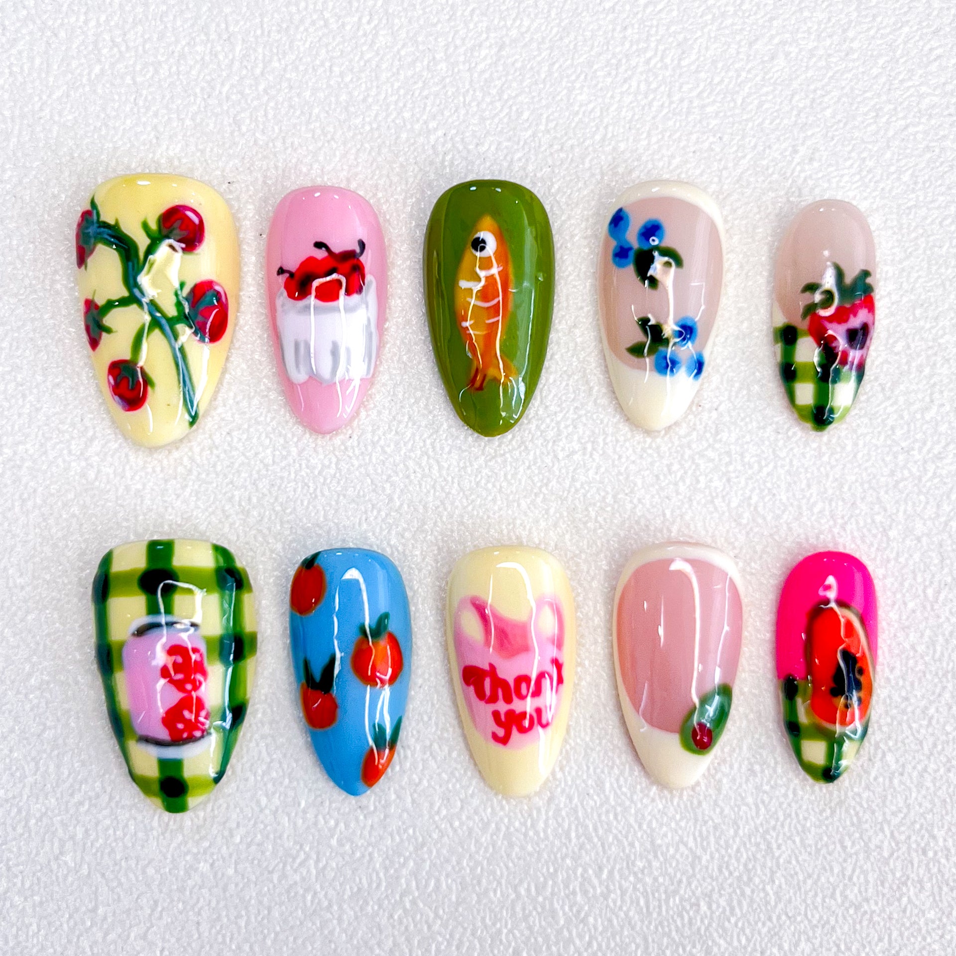 Garden Delight press-on nails with colorful fruit and flower patterns, perfect for a fresh and vibrant look.