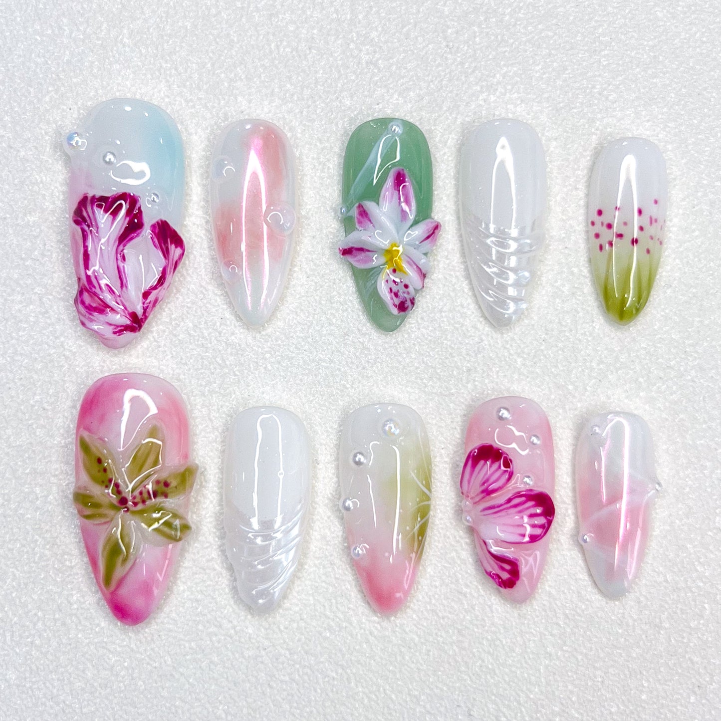 Floral Elegance press-on nails with intricate flower designs in shades of pink and green, offering a soft, nature-inspired look.