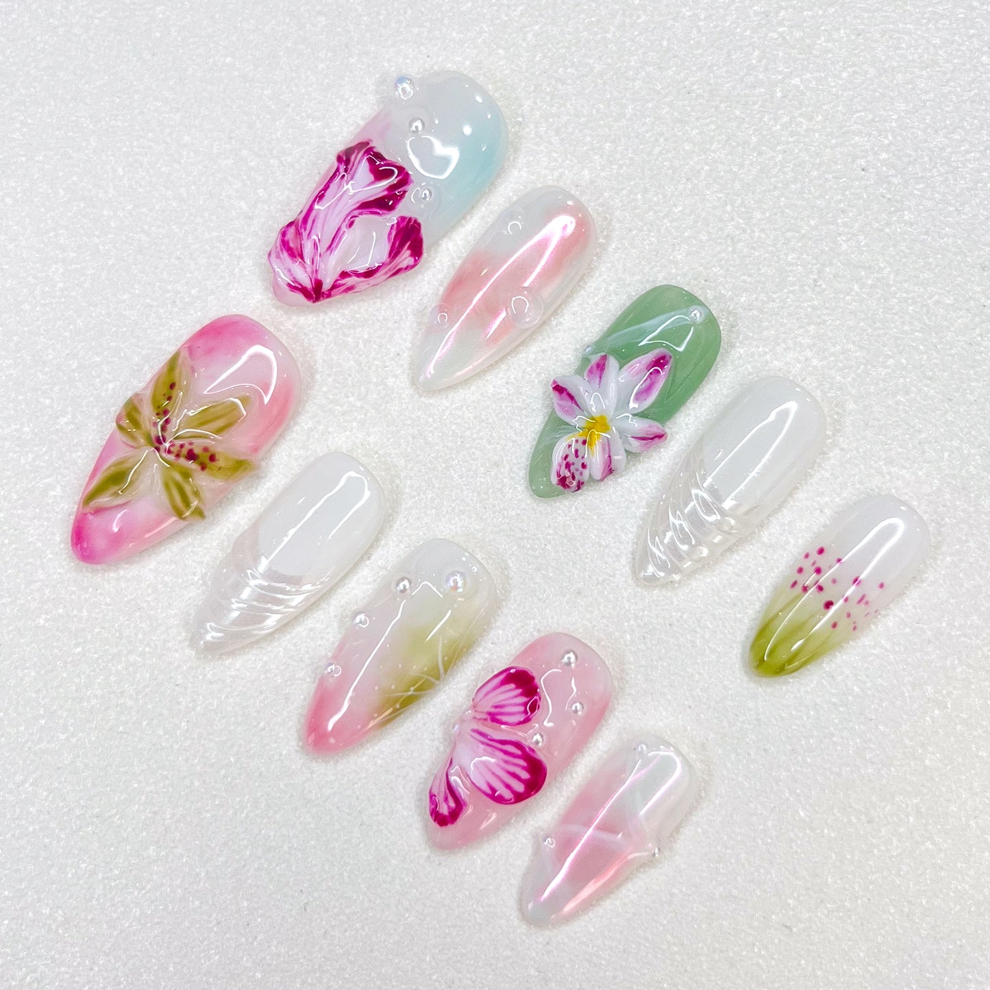 Floral Elegance press-on nails with intricate flower designs in shades of pink and green, offering a soft, nature-inspired look.