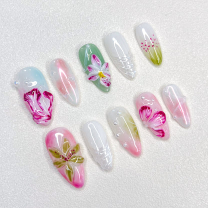 Floral Elegance press-on nails with intricate flower designs in shades of pink and green, offering a soft, nature-inspired look.