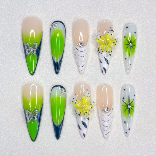 Neon Bloom press-on nails with neon green ombre, butterflies, and florals for a strikingly vibrant nature-inspired style.