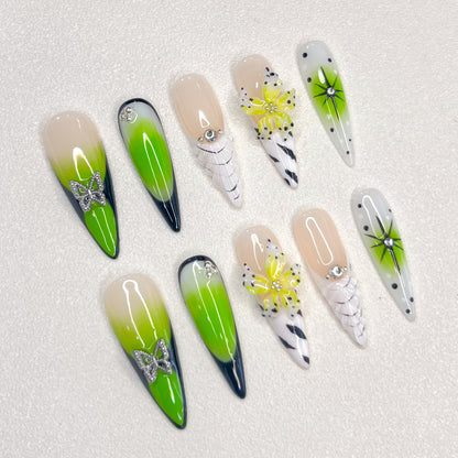 Neon Bloom press-on nails with neon green ombre, butterflies, and florals for a strikingly vibrant nature-inspired style.