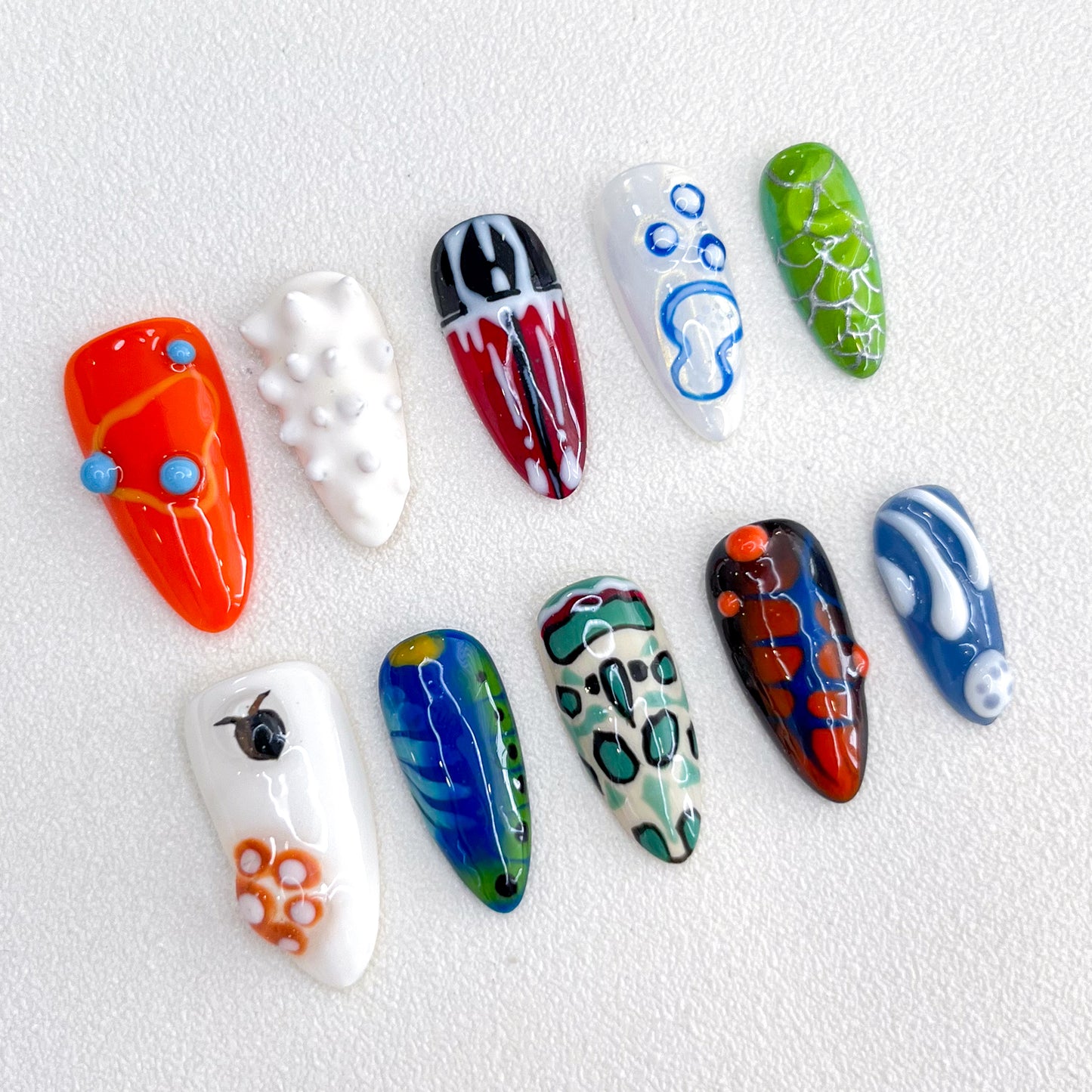 Abstract Pop press-on nails with colorful, abstract designs in vivid shades, adding a playful, artistic touch to your nails.