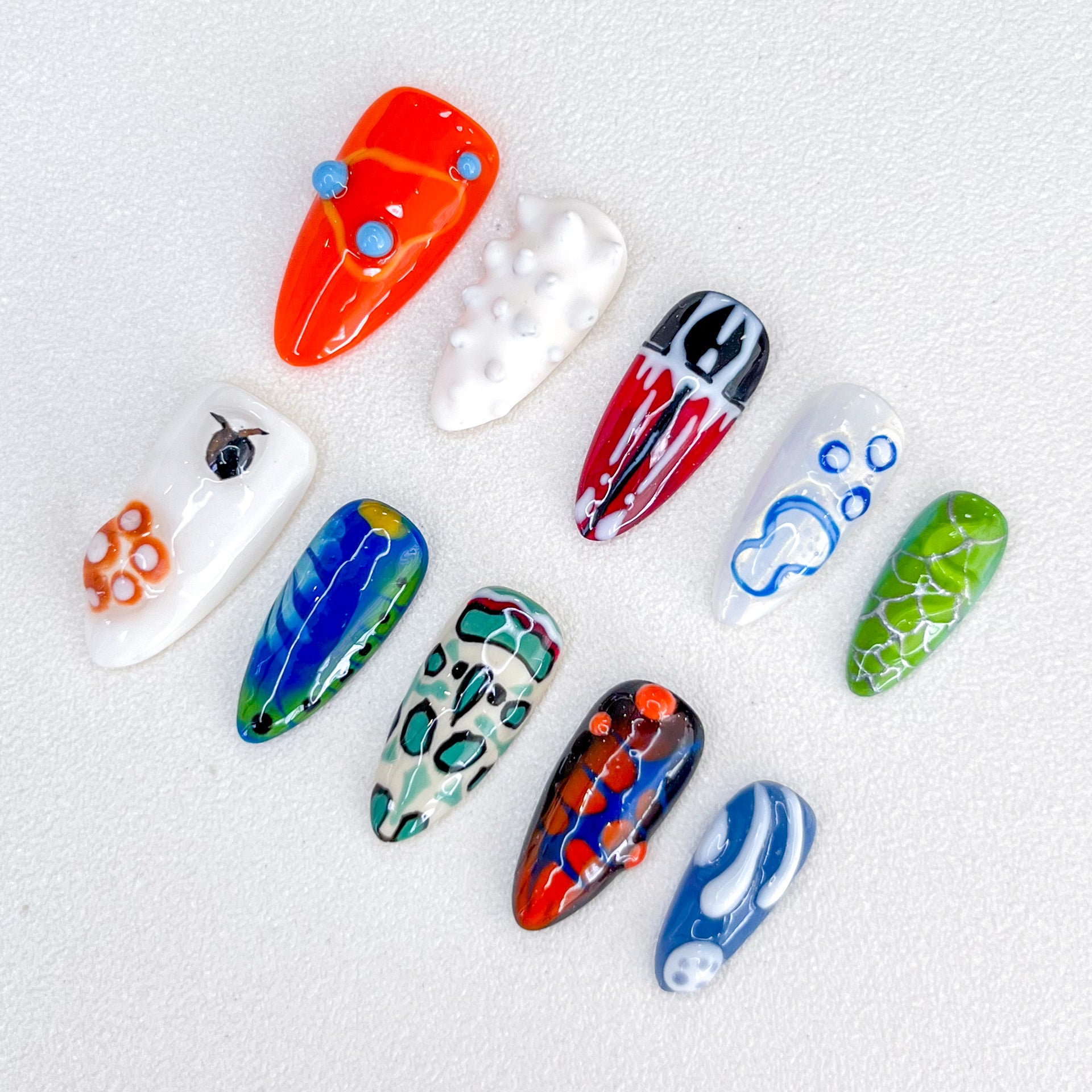 Abstract Pop press-on nails with colorful, abstract designs in vivid shades, adding a playful, artistic touch to your nails.