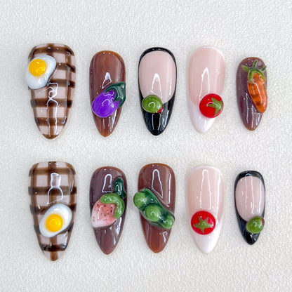 Farm Fresh press-on nails with 3D vegetable designs, including carrots, eggplants, and tomatoes, for a fun and quirky nail art style.