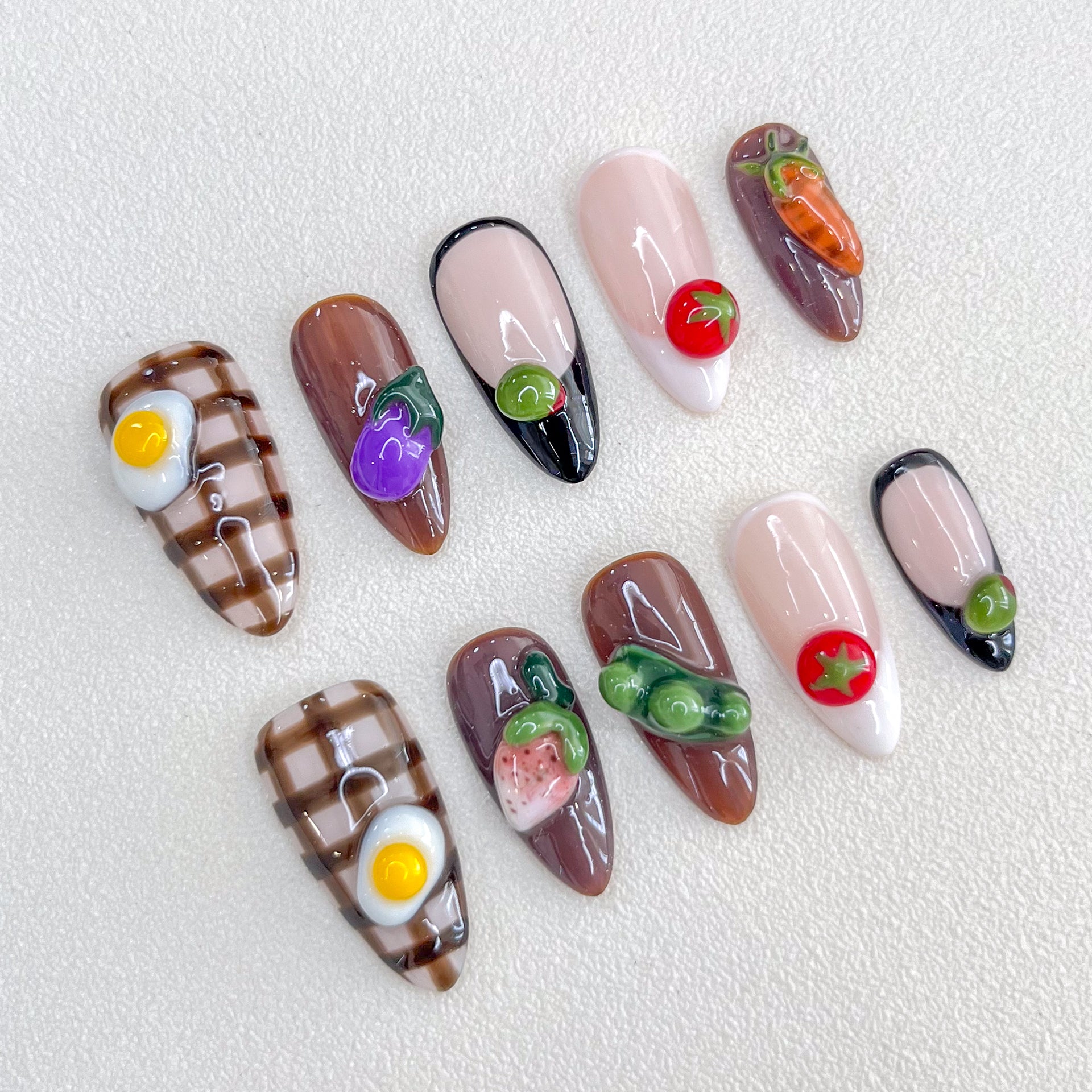 Farm Fresh press-on nails with 3D vegetable designs, including carrots, eggplants, and tomatoes, for a fun and quirky nail art style.