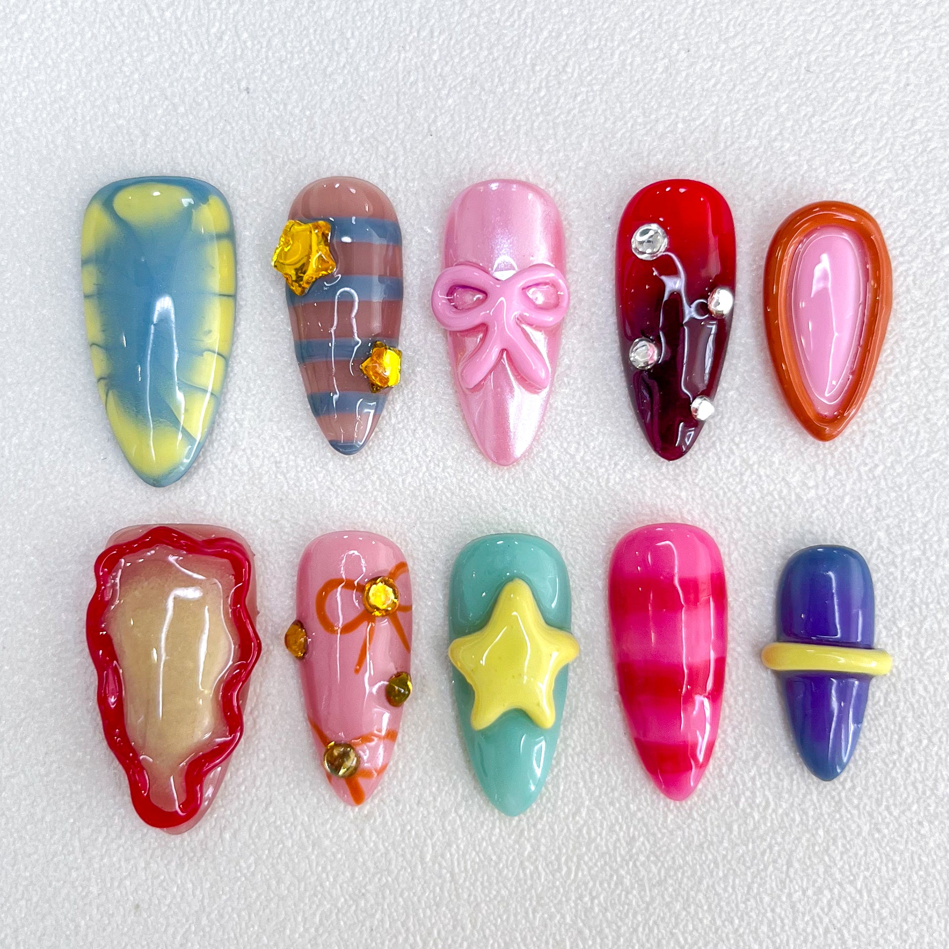 Candy Delight press-on nails with bright colors, 3D bows, and star details for a cute, playful, and sweet design.