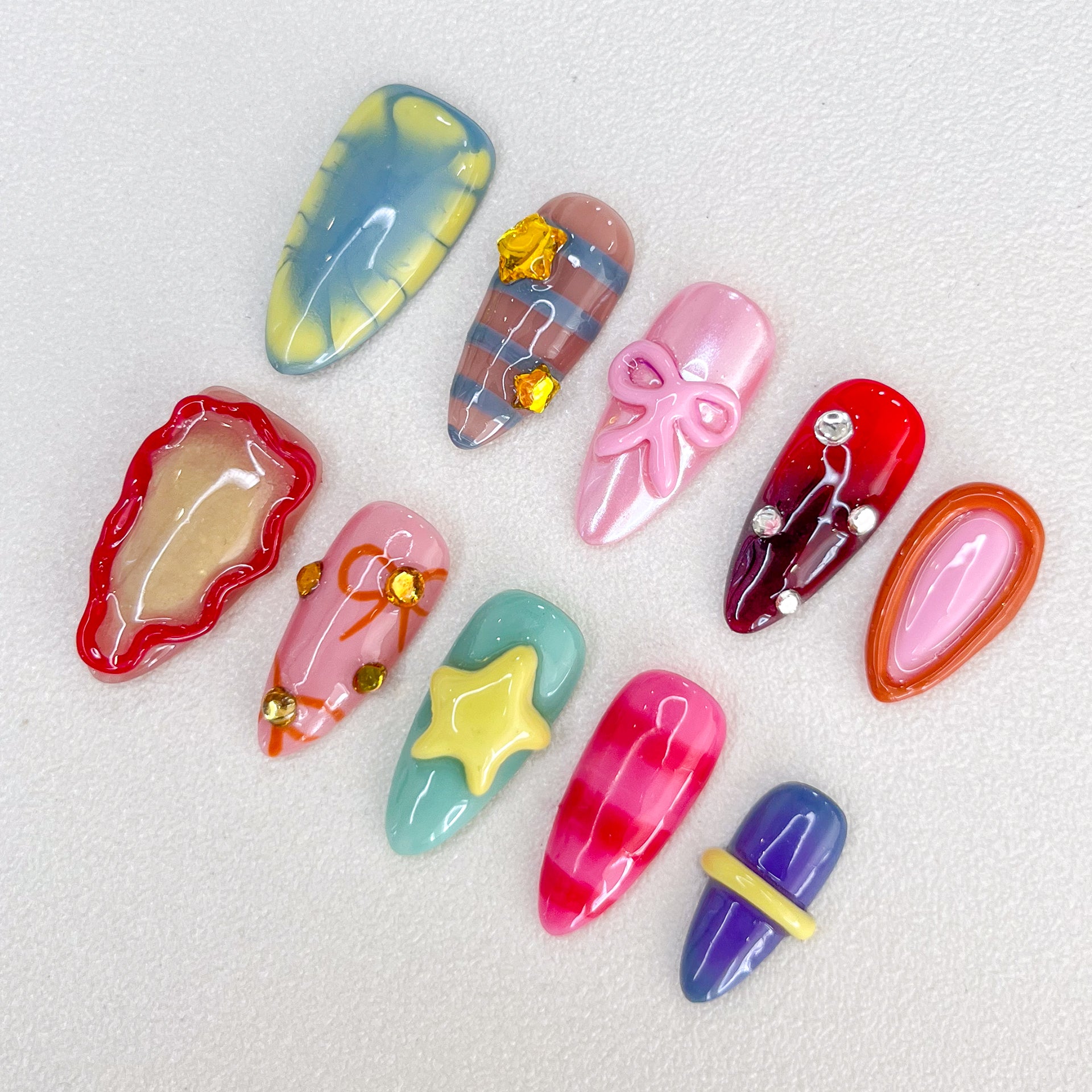 Candy Delight press-on nails with bright colors, 3D bows, and star details for a cute, playful, and sweet design.