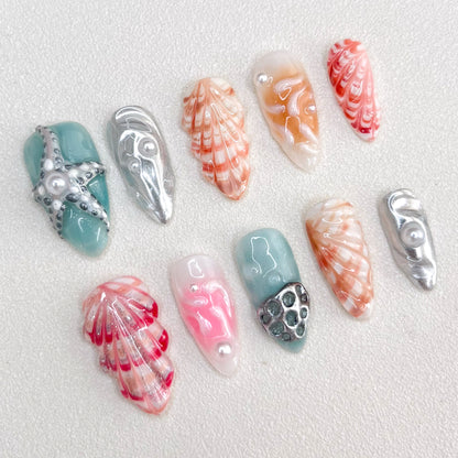 Oceanic Elegance press-on nails with seashell patterns, starfish accents, and ocean-inspired colors for a sophisticated seaside style.