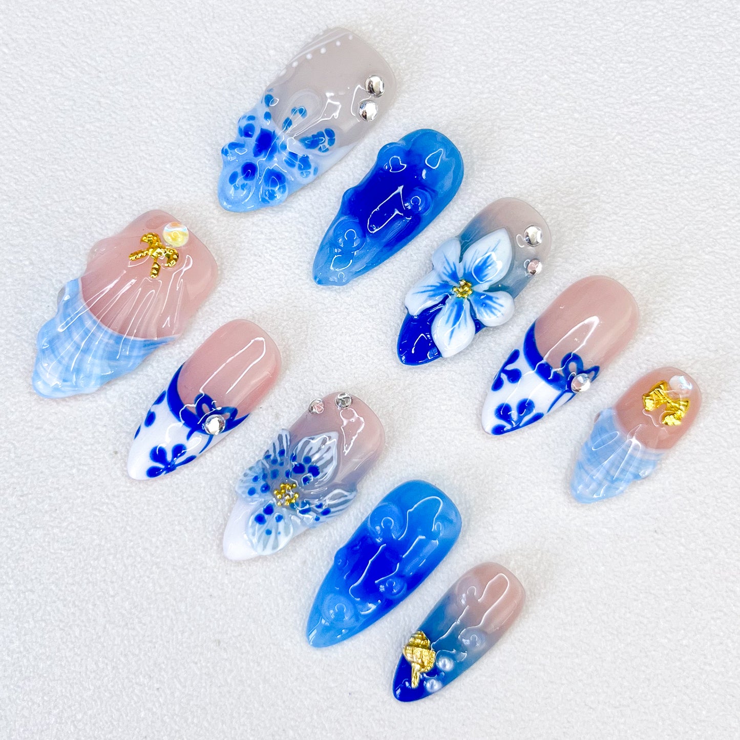 Celestial Bloom press-on nails with intricate blue floral designs and white porcelain-inspired patterns for a graceful, nature-inspired style.