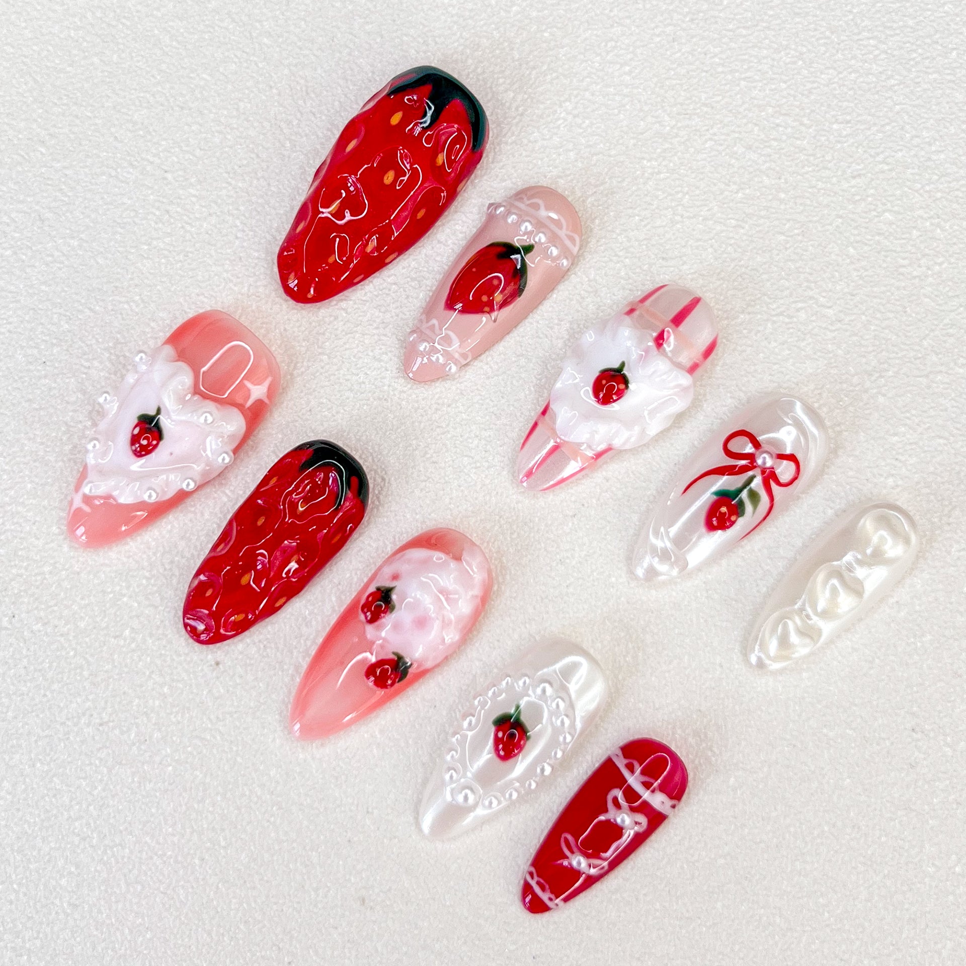 Sweet Berry Dream press-on nails with strawberry motifs, lace patterns, and pearl details for a whimsical, romantic style.