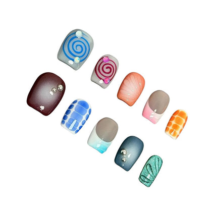 A press-on nail set with colorful spirals, gradient effects, geometric patterns, and gemstone accents, offering a playful and creative design.