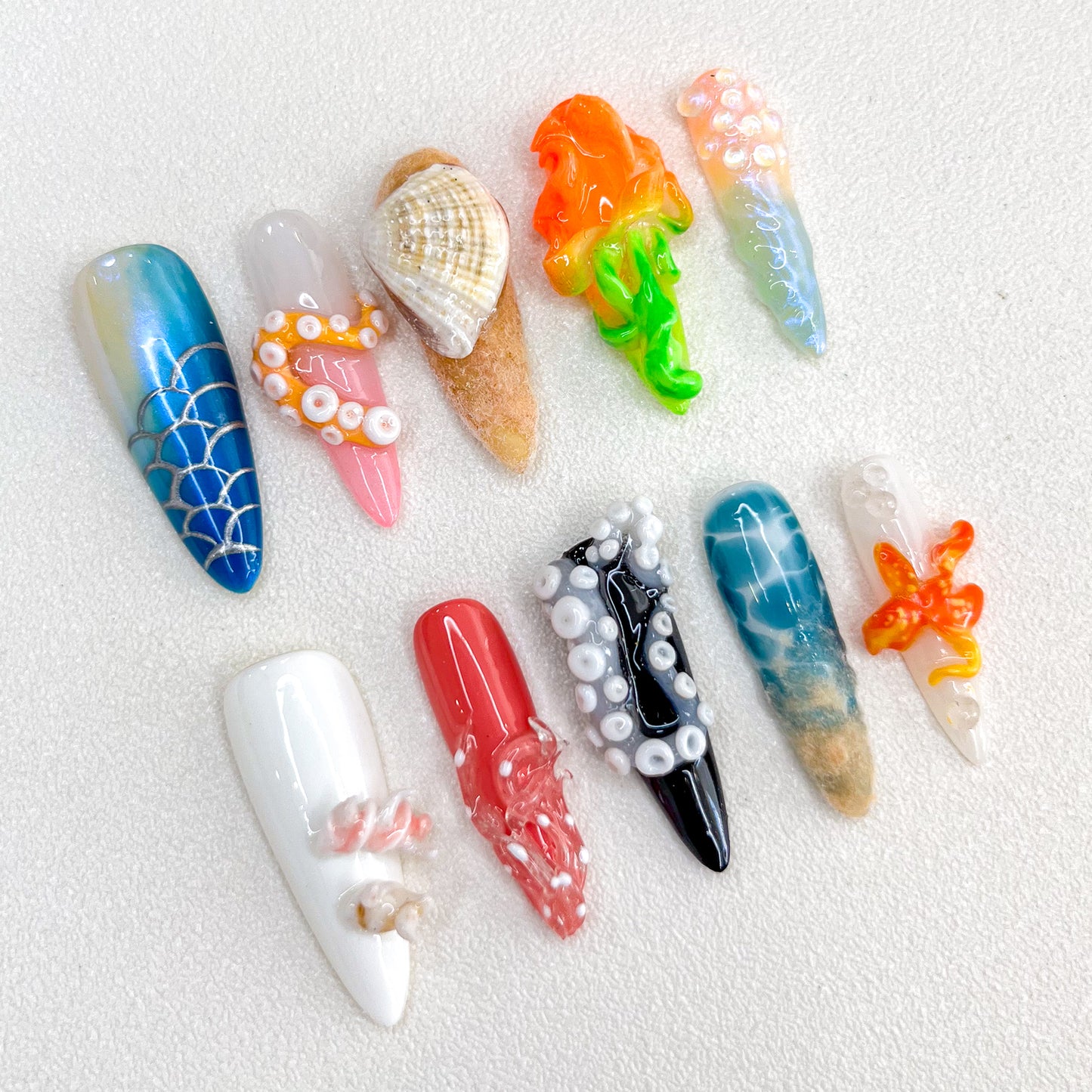 Underwater Fantasy press-on nails with coral, shells, and aquatic details in bold, colorful tones, perfect for ocean lovers.