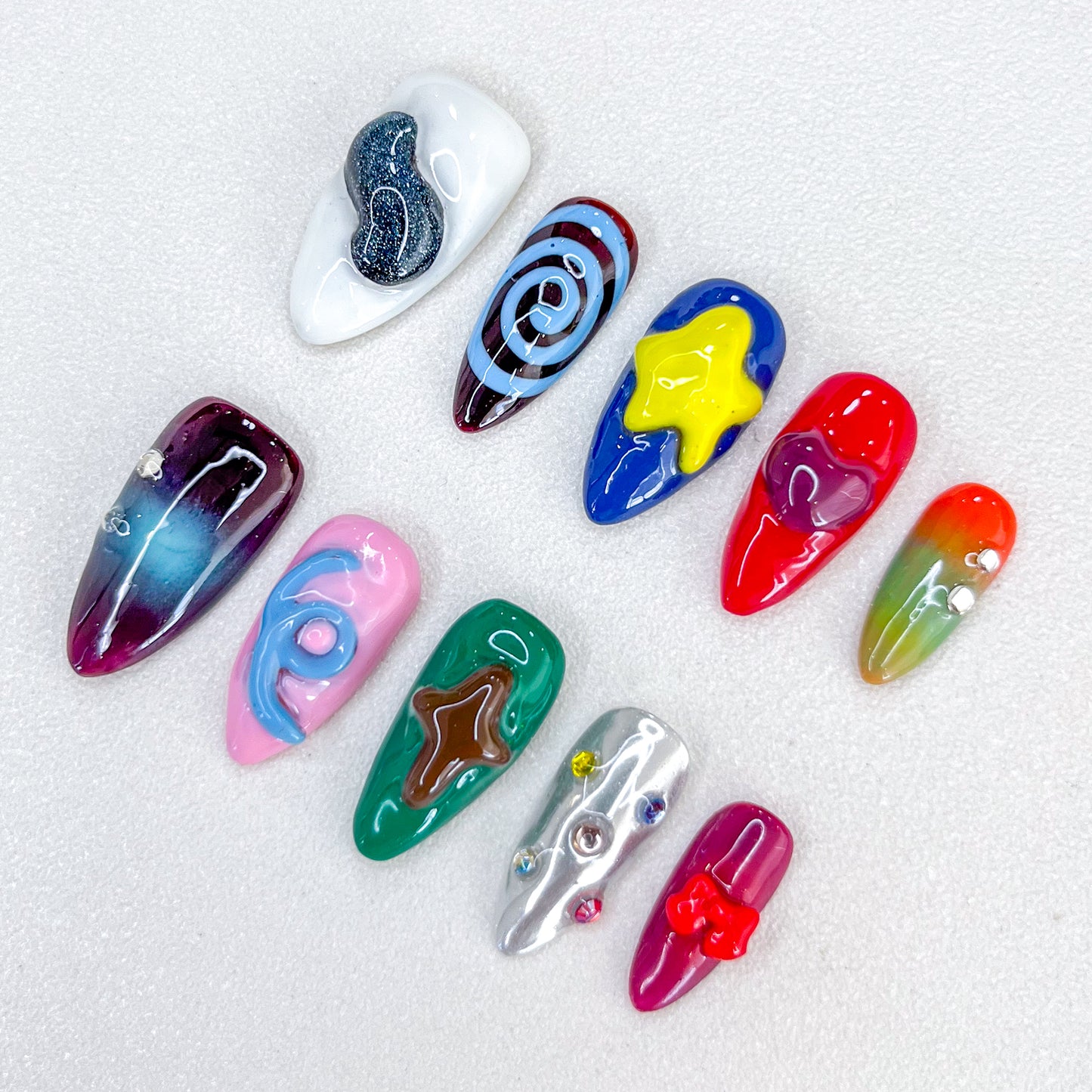 Cosmic Delight press-on nails with bold planetary and star designs in vivid colors, perfect for a unique, galactic look.