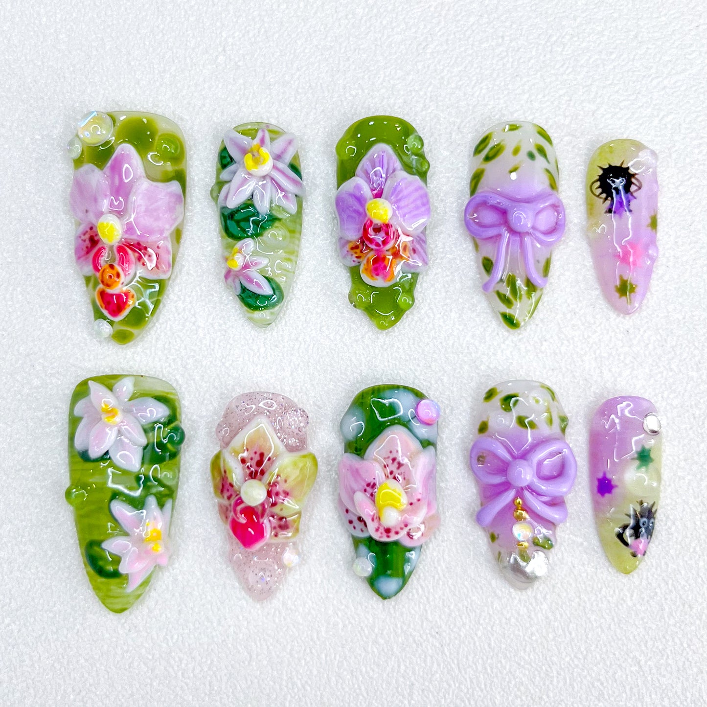 Orchid Whisper press-on nails with intricate orchid flowers and natural green tones for an elegant and graceful style.