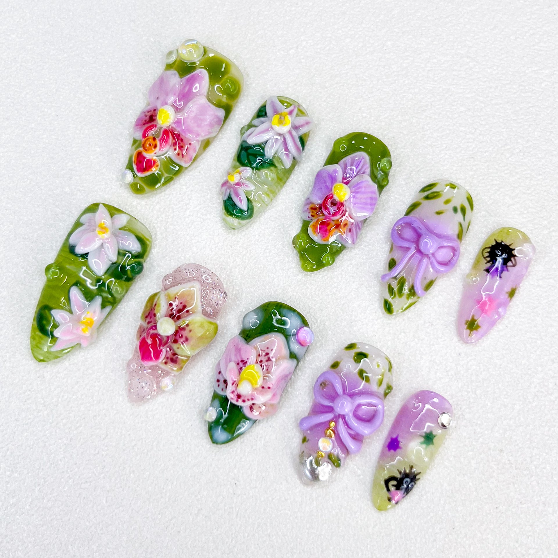 Orchid Whisper press-on nails with intricate orchid flowers and natural green tones for an elegant and graceful style.