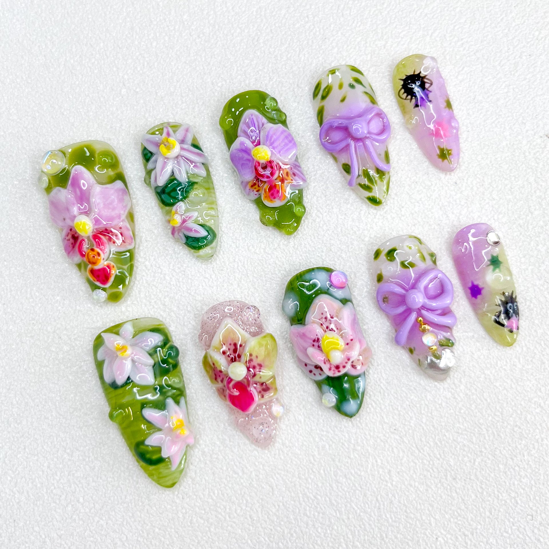 Orchid Whisper press-on nails with intricate orchid flowers and natural green tones for an elegant and graceful style.