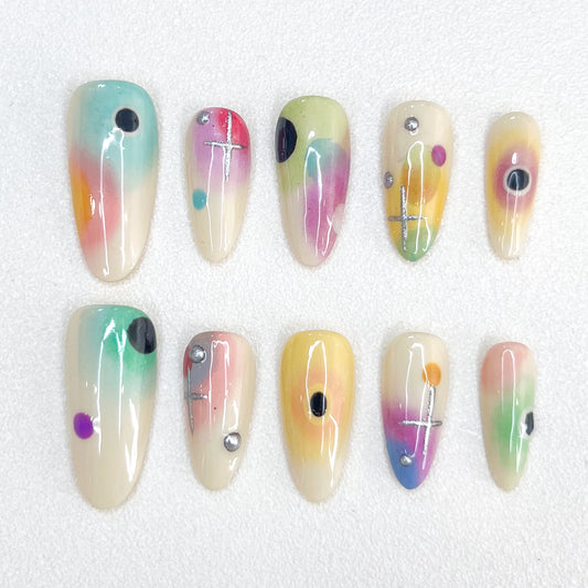 Cosmic Fade press-on nails with dreamy ombre colors and celestial geometric details, offering a soft, ethereal style.