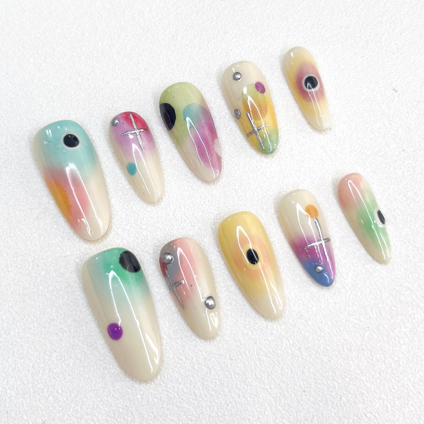 Cosmic Fade press-on nails with dreamy ombre colors and celestial geometric details, offering a soft, ethereal style.