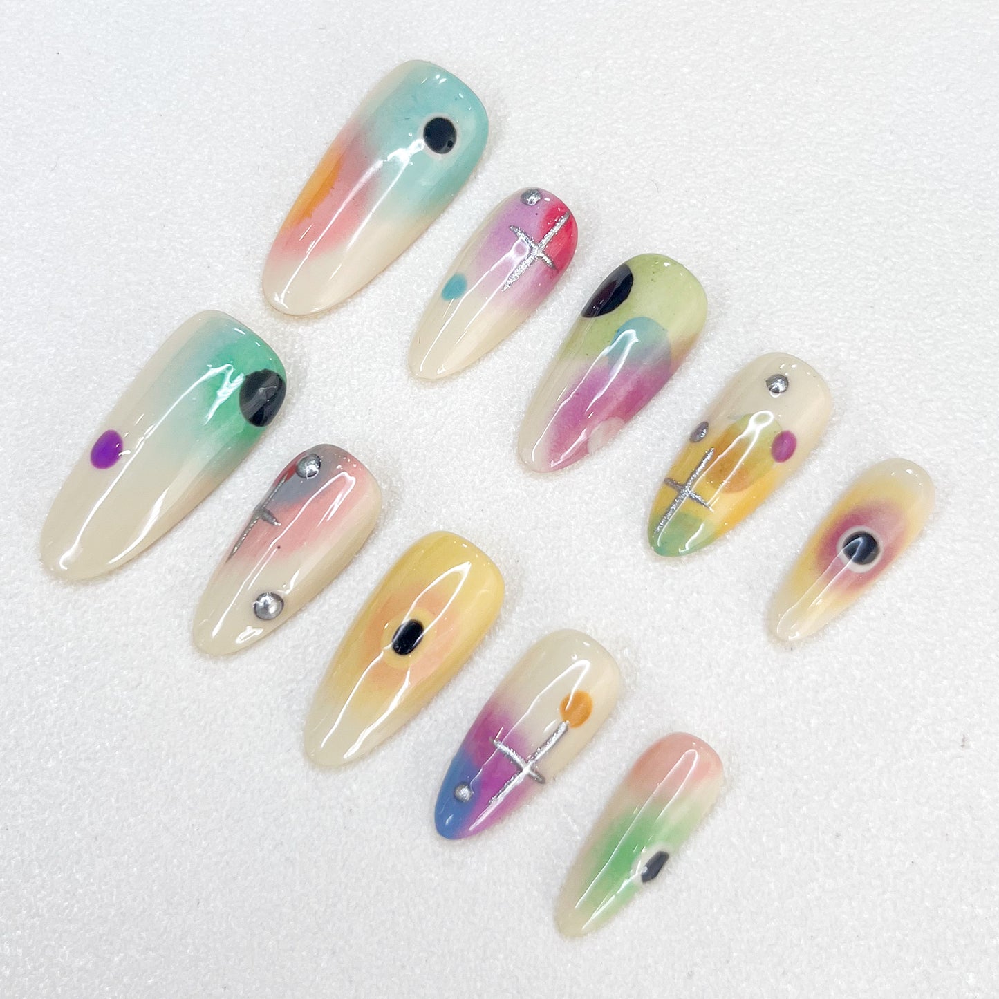 Cosmic Fade press-on nails with dreamy ombre colors and celestial geometric details, offering a soft, ethereal style.