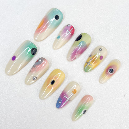 Cosmic Fade press-on nails with dreamy ombre colors and celestial geometric details, offering a soft, ethereal style.