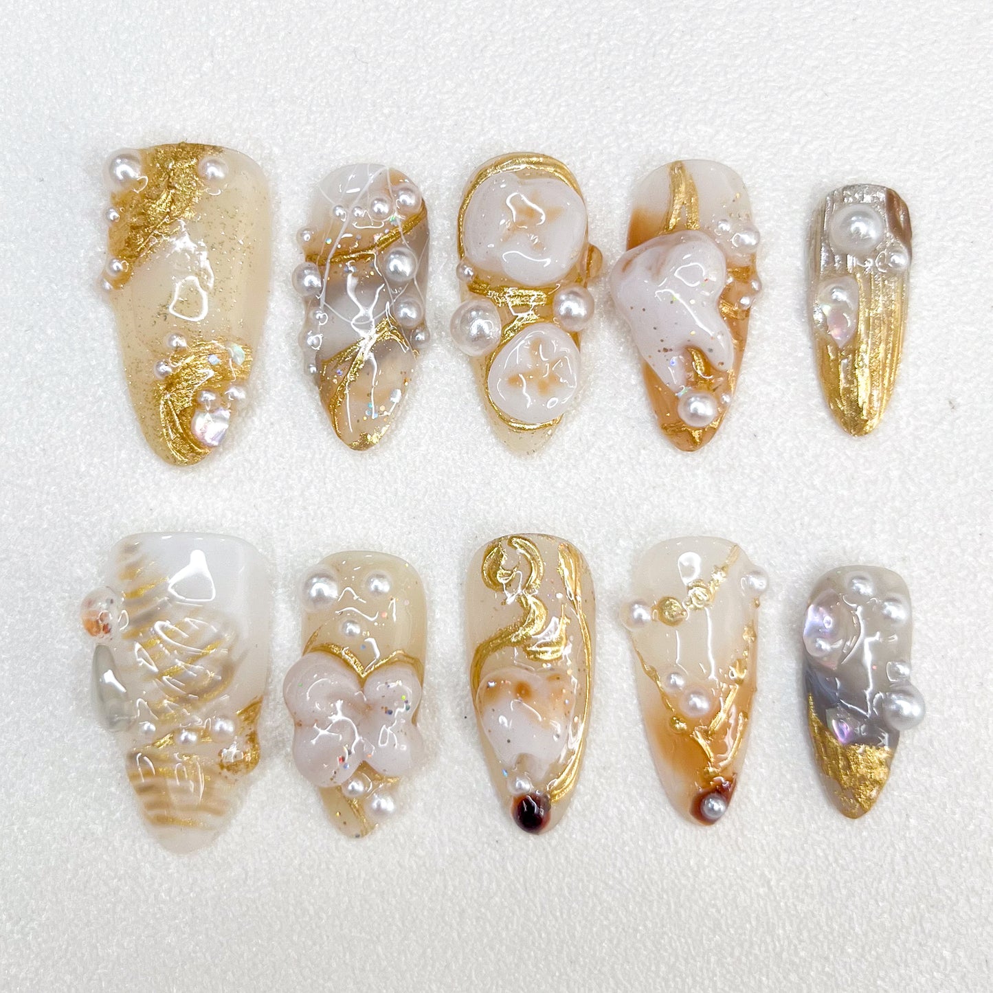 Golden Pearl press-on nails with gold details, pearl accents, and a refined aesthetic for timeless elegance.