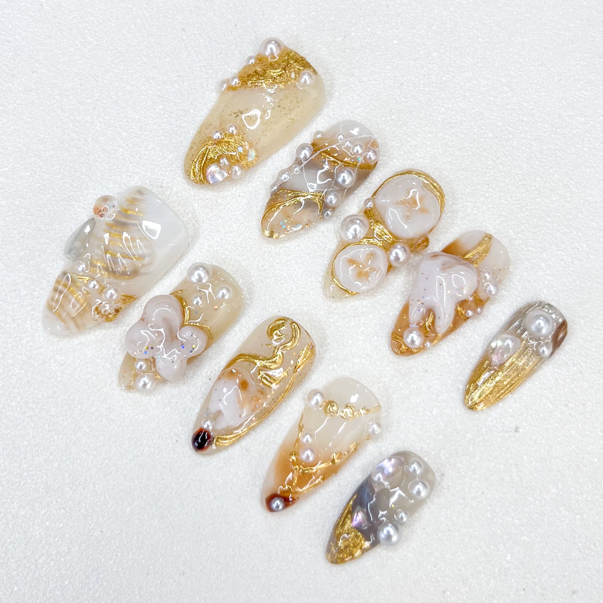 Golden Pearl press-on nails with gold details, pearl accents, and a refined aesthetic for timeless elegance.