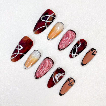 Crimson Velvet press-on nails with deep red tones and elegant silver accents for a striking appearance.