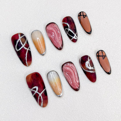 Crimson Velvet press-on nails with deep red tones and elegant silver accents for a striking appearance.