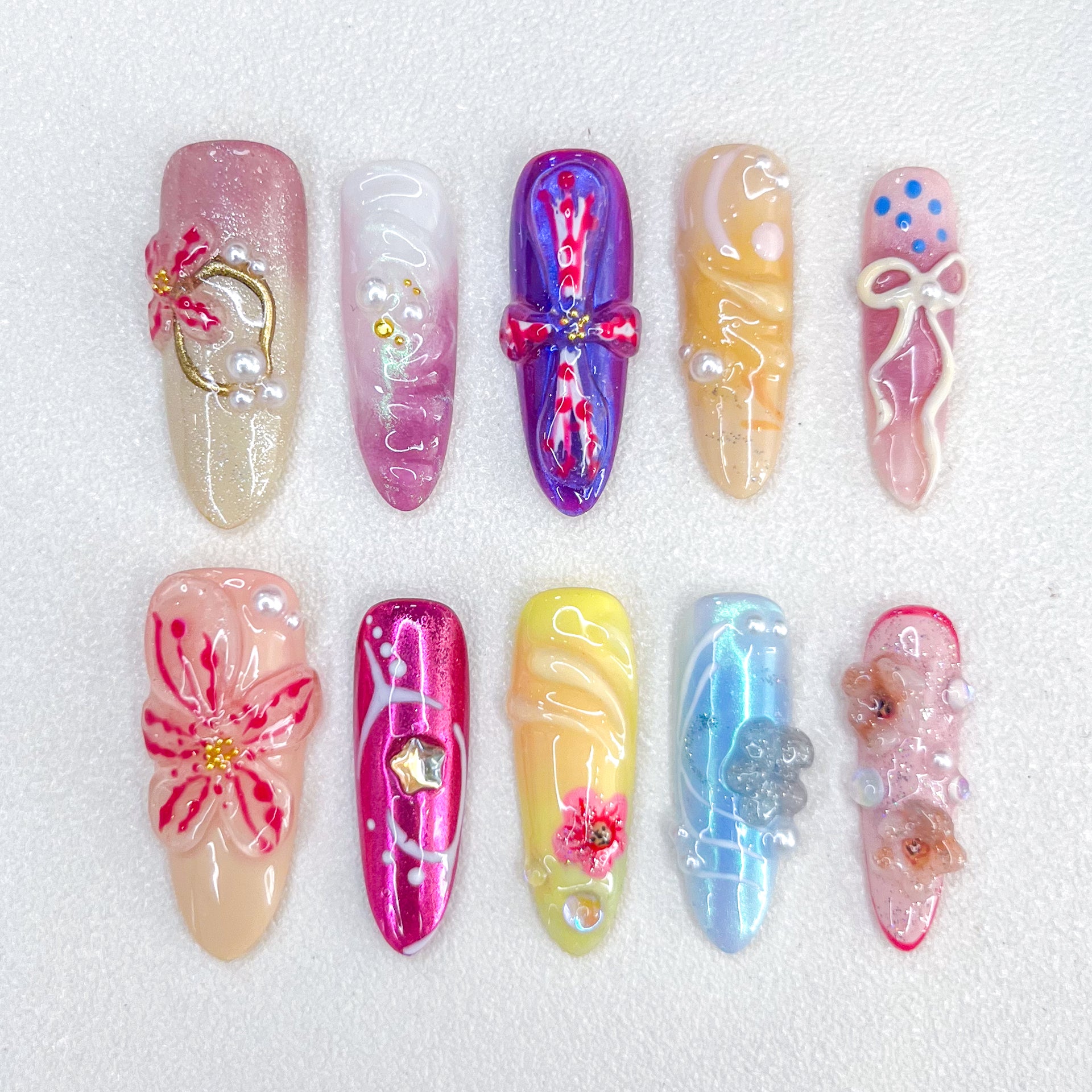 Ballet Bloom press-on nails with ribbon and floral designs, paired with soft pastel shades for a sophisticated look.