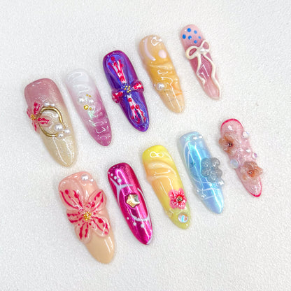 Ballet Bloom press-on nails with ribbon and floral designs, paired with soft pastel shades for a sophisticated look.