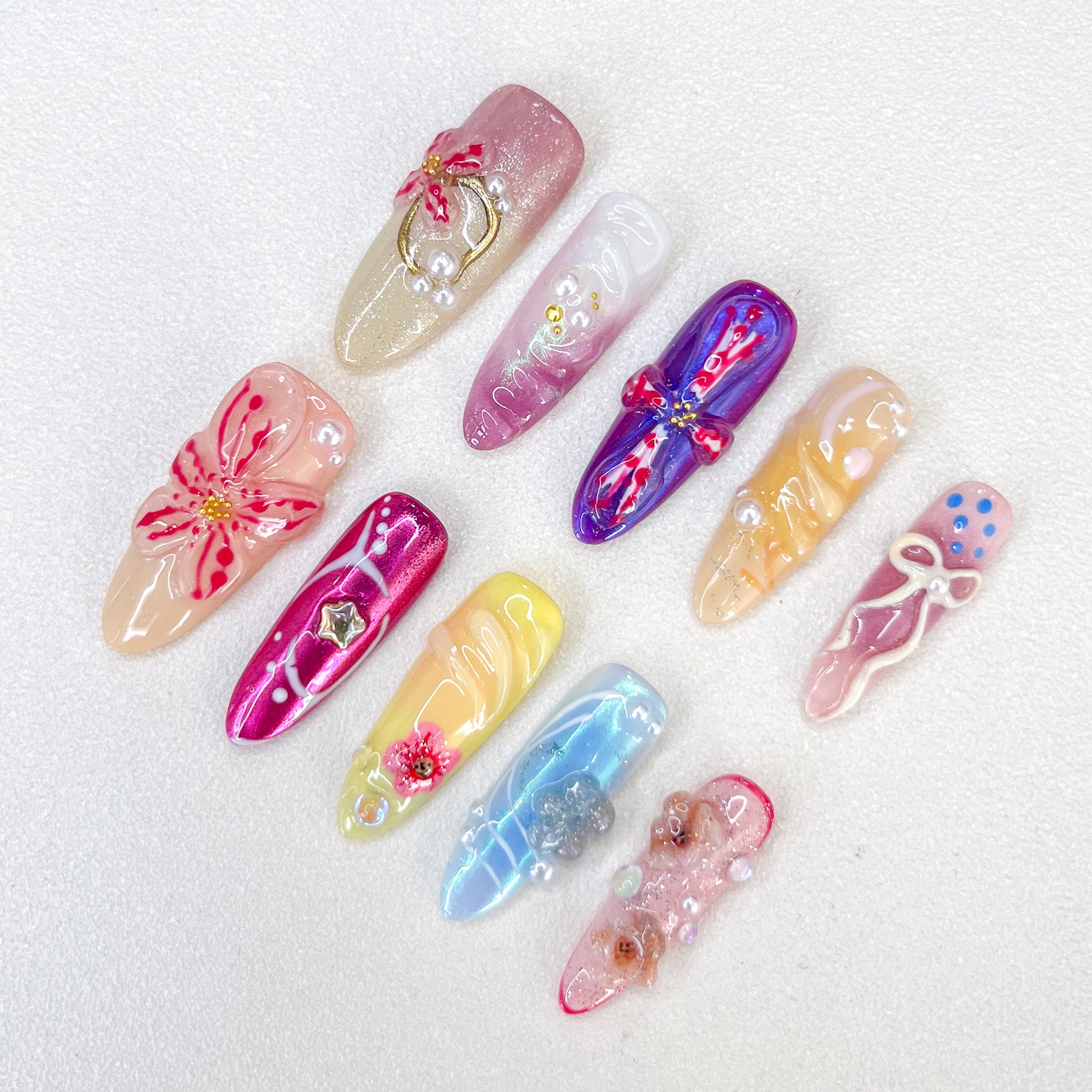 Ballet Bloom press-on nails with ribbon and floral designs, paired with soft pastel shades for a sophisticated look.