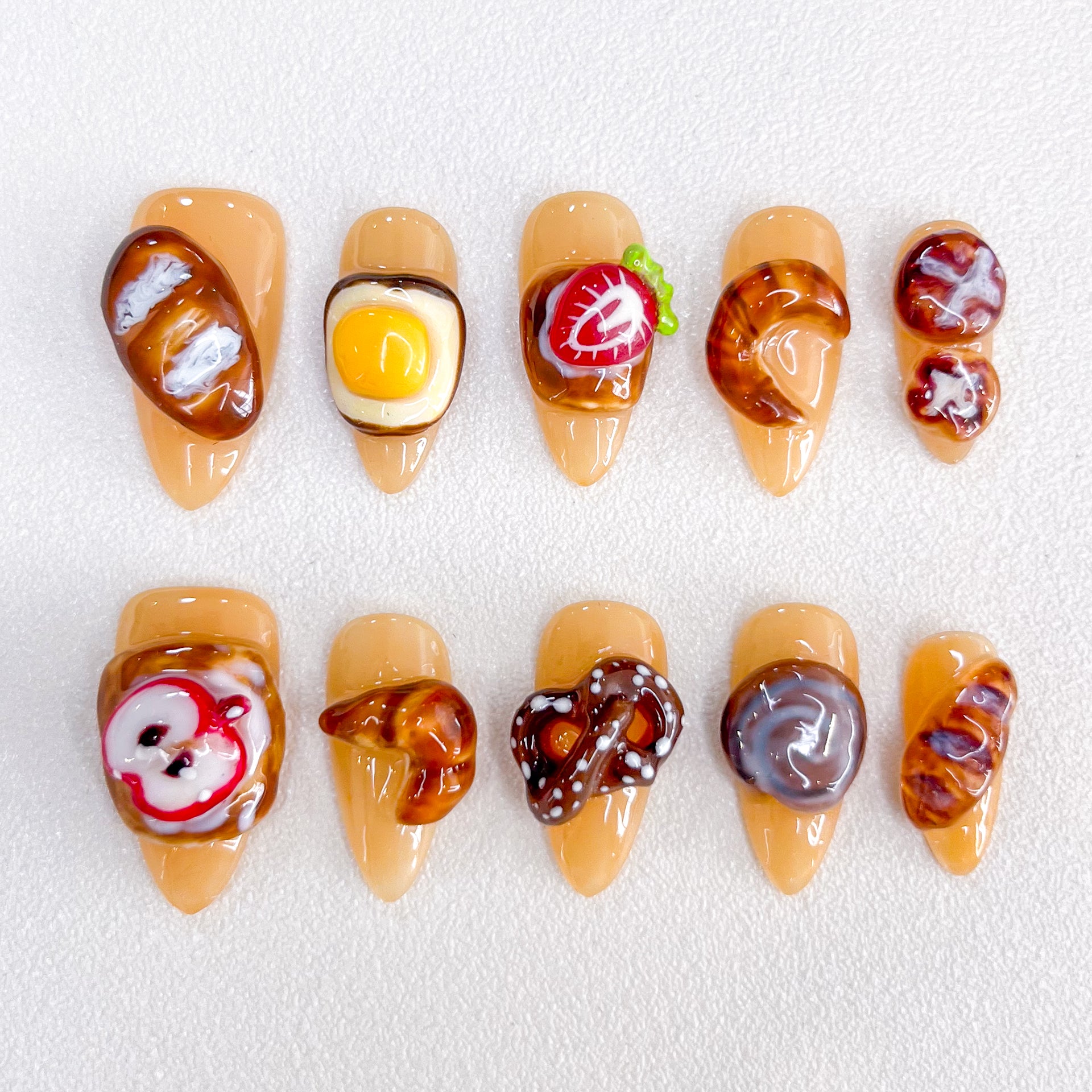 Bakery Bliss press-on nails with realistic pastry designs, perfect for those who love cute and creative nail art.