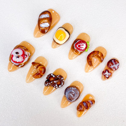 Bakery Bliss press-on nails with realistic pastry designs, perfect for those who love cute and creative nail art.