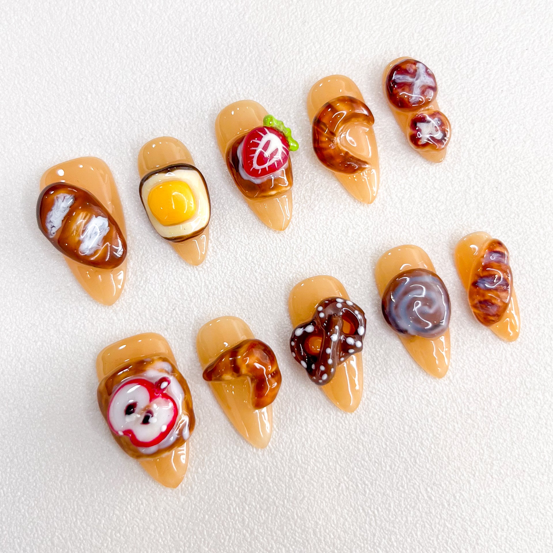 Bakery Bliss press-on nails with realistic pastry designs, perfect for those who love cute and creative nail art.