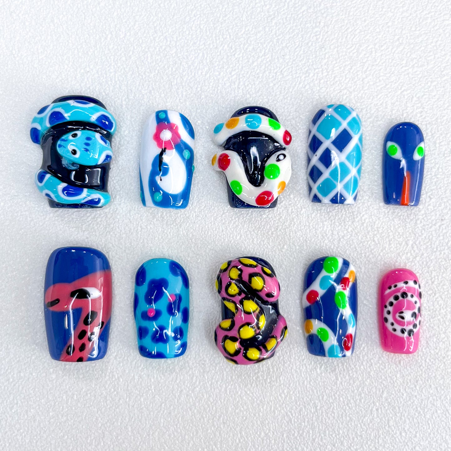 Carnival Creatures press-on nails with playful reptile designs and bold colors, perfect for making a statement.