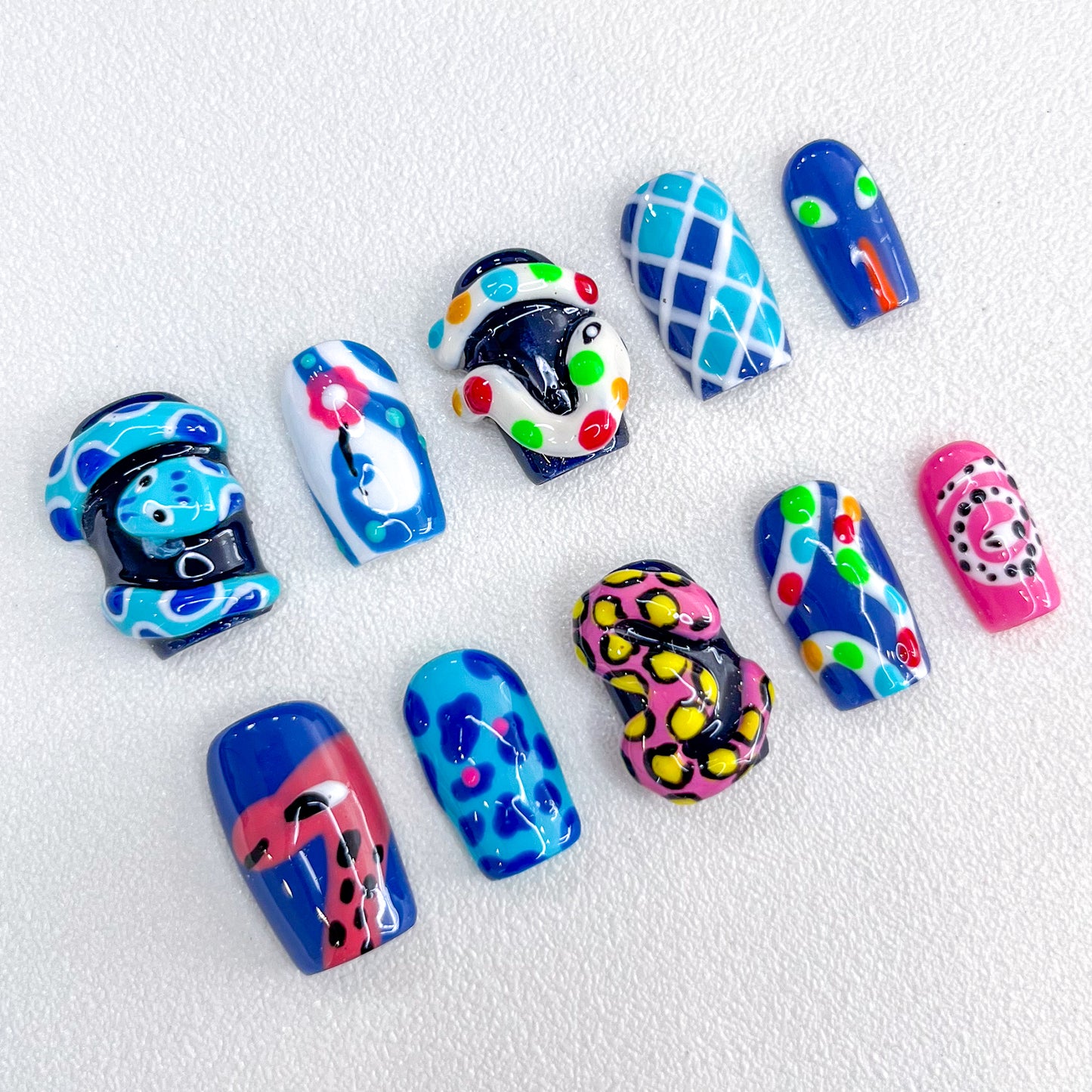 Carnival Creatures press-on nails with playful reptile designs and bold colors, perfect for making a statement.