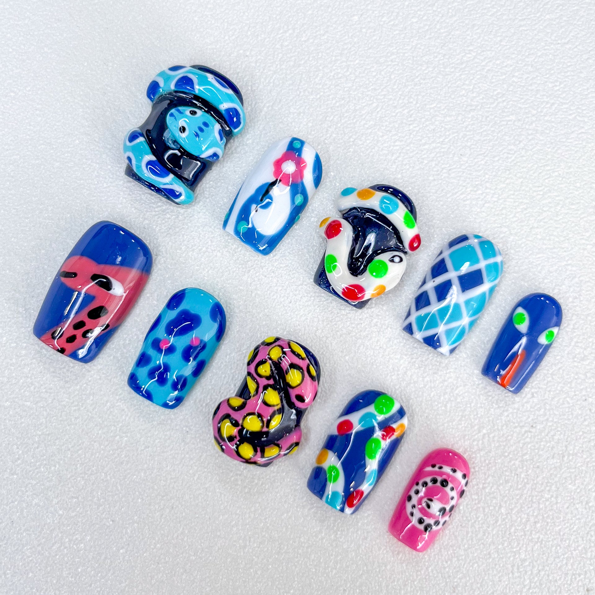 Carnival Creatures press-on nails with playful reptile designs and bold colors, perfect for making a statement.