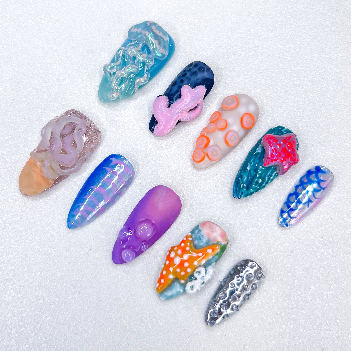 A unique ocean-themed nail art set by Lris Nails featuring 3D jellyfish, coral reefs, starfish, and ocean textures. Vibrant colors and intricate marine-inspired designs bring underwater beauty to your nails.