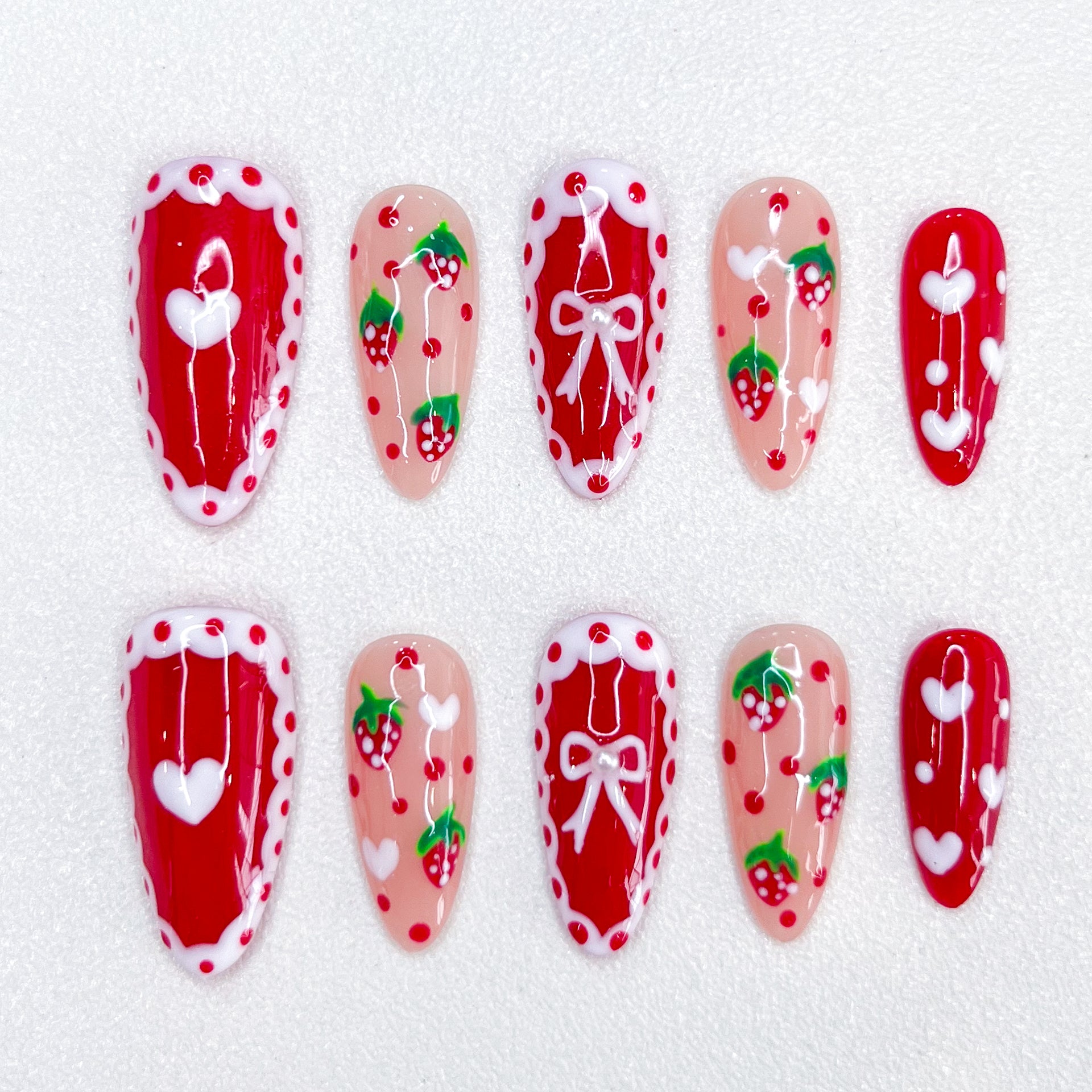 Berry Delight press-on nails with strawberry and lace designs, adding a touch of sweetness to your look.