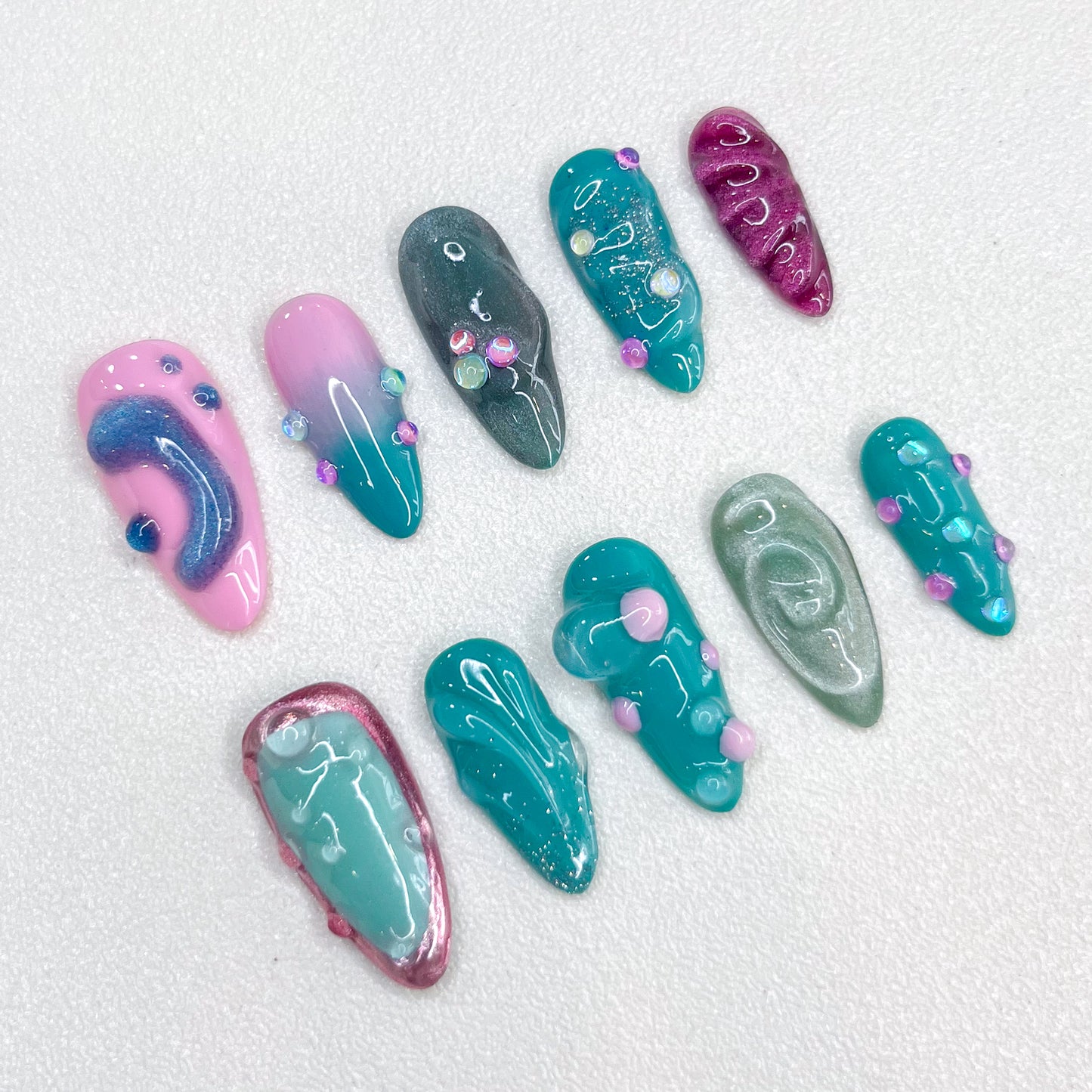 Pastel Lagoon press-on nails with pastel shades and 3D accents for a dreamy aesthetic.