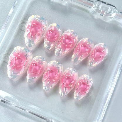 A set of press - on nails with a vibrant pink color and an iridescent finish, giving them a bold and edgy appearance. The nails are perfect for making a statement at parties or events.