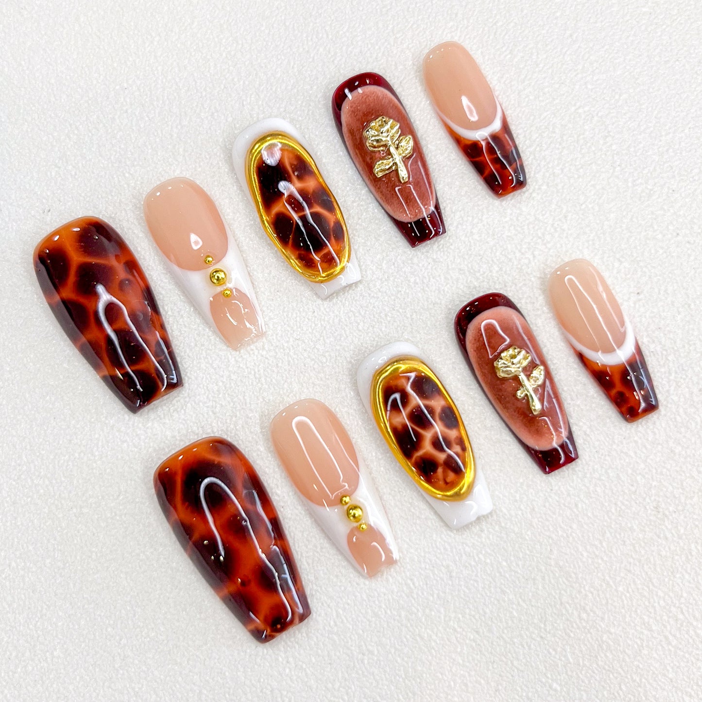 Tortoise Luxe press-on nails with a timeless tortoiseshell pattern, featuring gold details for a refined and modern aesthetic.