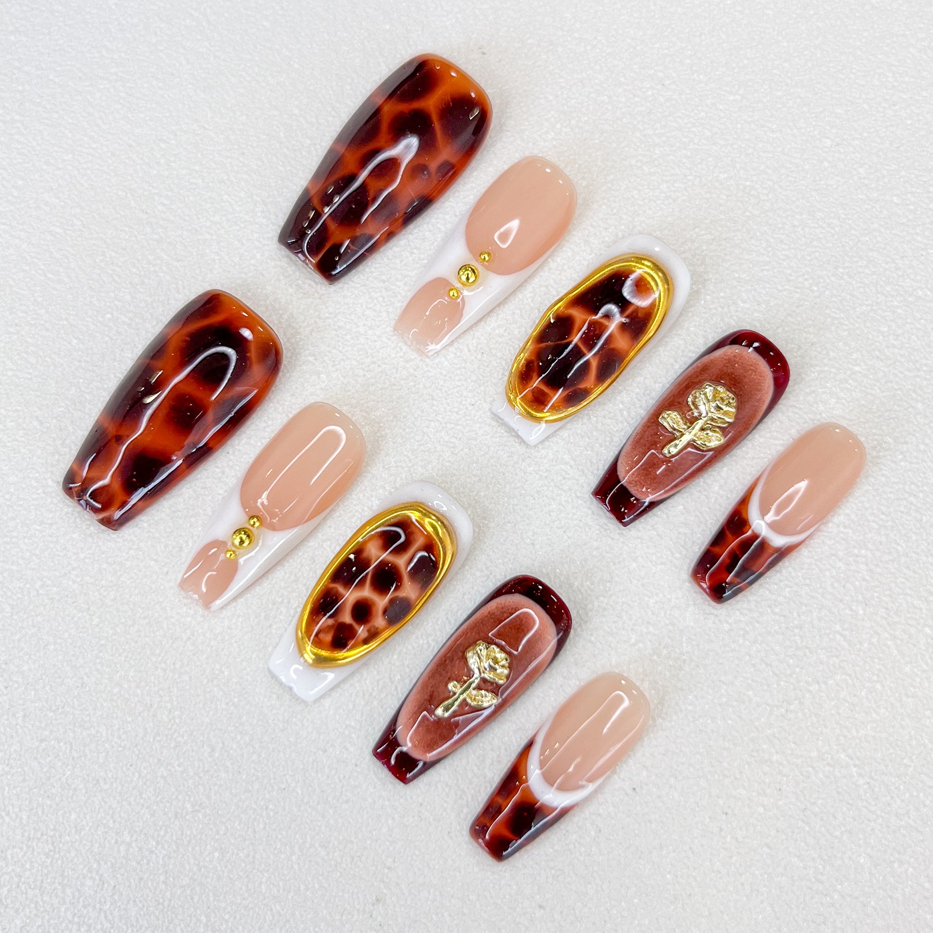 Tortoise Luxe press-on nails with a timeless tortoiseshell pattern, featuring gold details for a refined and modern aesthetic.