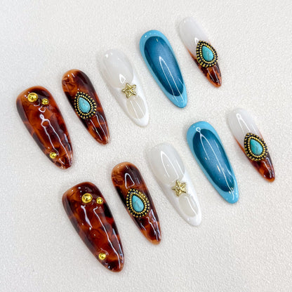 Desert Star press-on nails with tortoiseshell patterns and turquoise details, perfect for a desert-inspired, bohemian chic vibe.