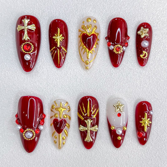 Divine Passion press-on nails with bold red and gold designs featuring crosses and celestial motifs, creating a dramatic and powerful style.