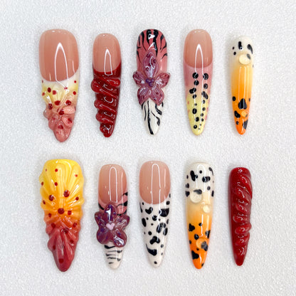 Safari Sunset press-on nails with vibrant sunset hues, animal prints, and floral details, offering an adventurous and bold style.