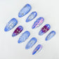 Lavender Twilight press-on nails featuring soft lavender ombre, shimmering silver details, and crystal-like embellishments for a calming, mystical style.